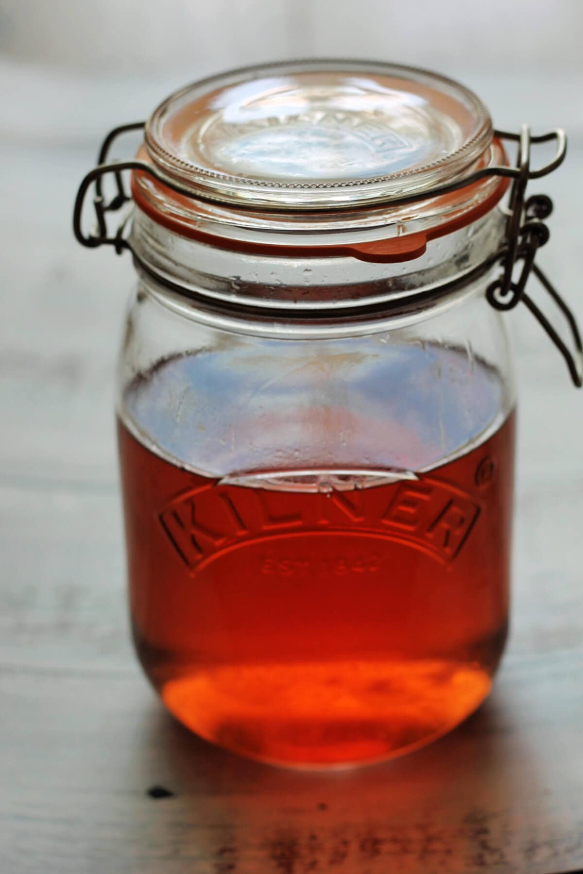 Red gin in a large jar.