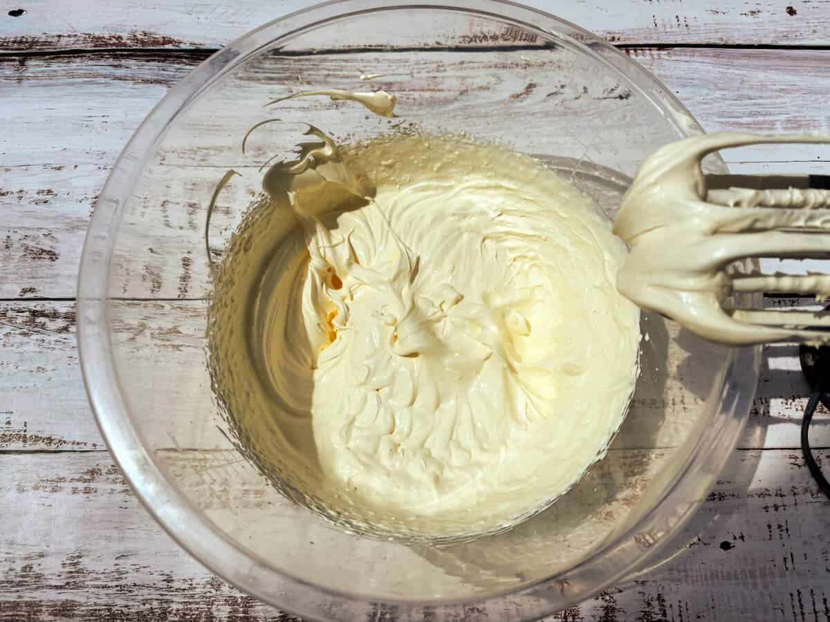Whipped cream in a clear bowl.