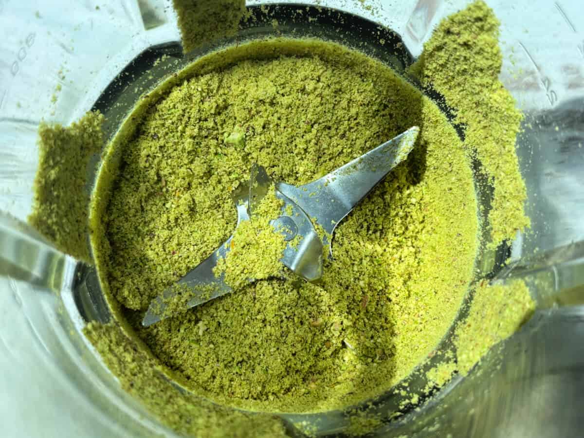 Ground pistachios in base of a blender.