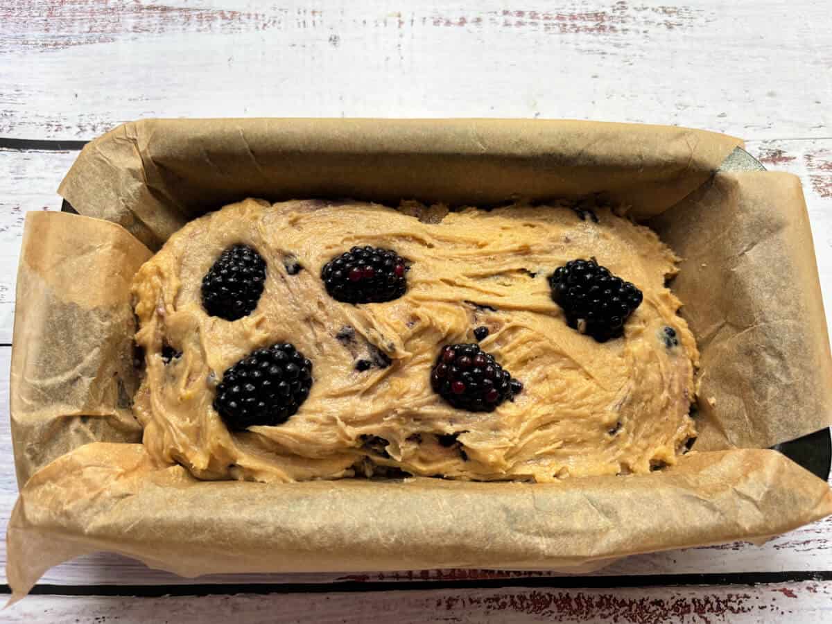 Cake mixture in lined loaf tin, ready to bake.