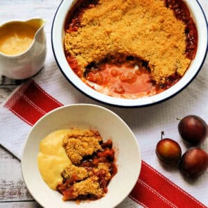 Crumble in serving dish and a bowl with custard.