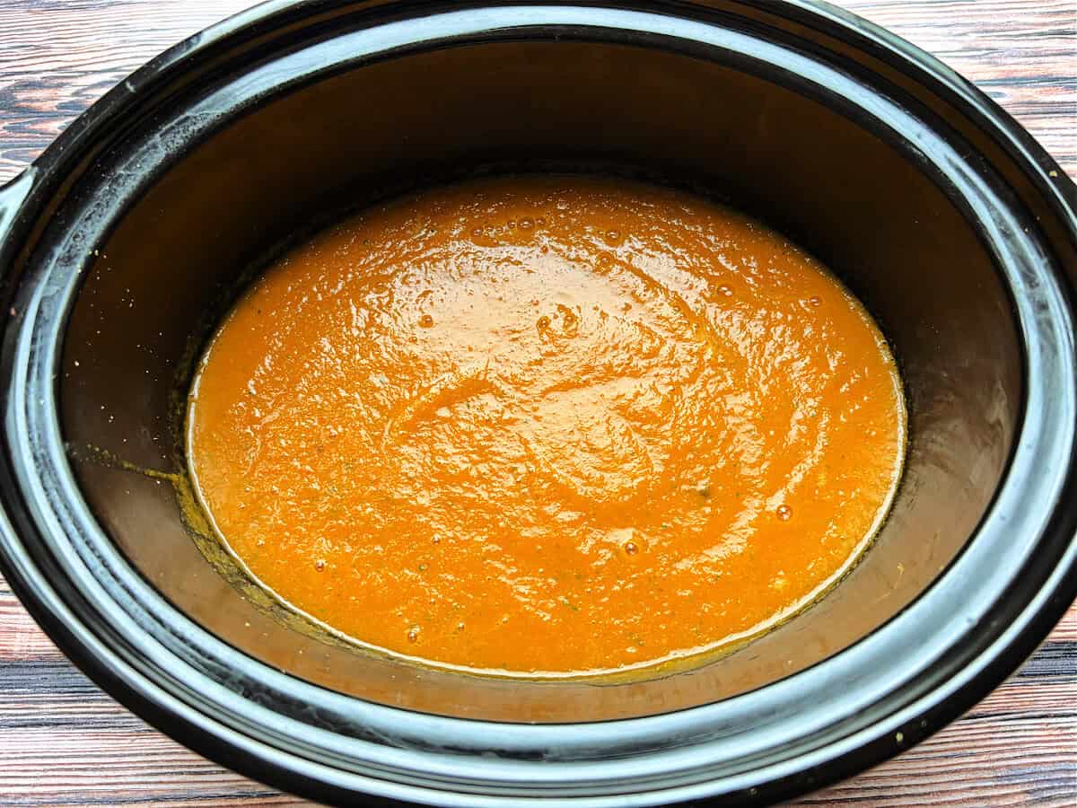 Cooked blended soup in slow cooker pot.