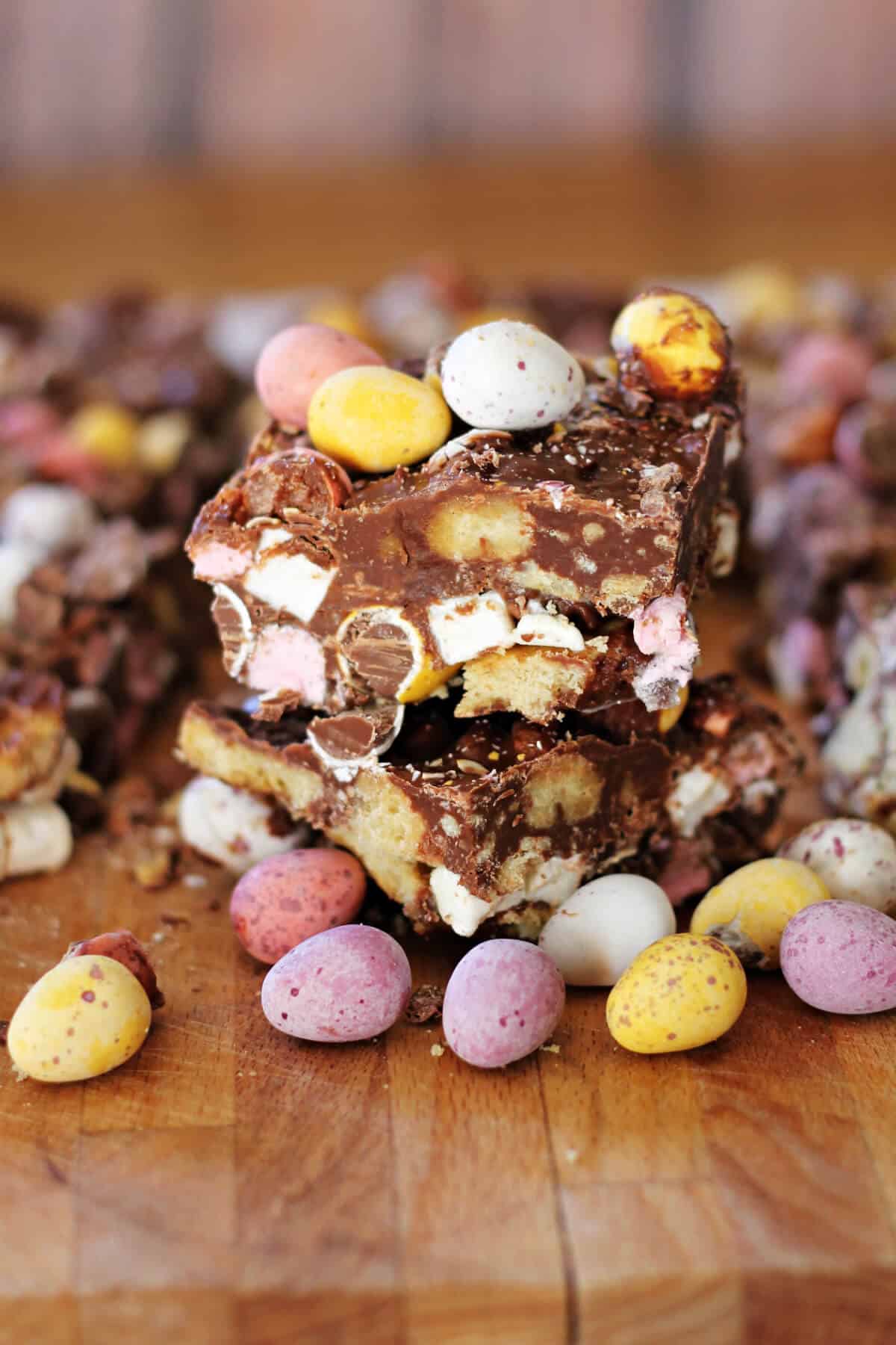 Stack of rocky road squares with mini eggs in front.