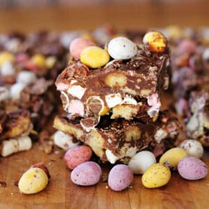 Two stacked pieces of colourful mini egg rocky road.