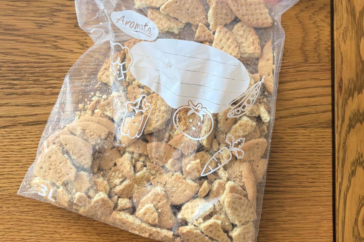Crushed digestive biscuits in a freezer bag.