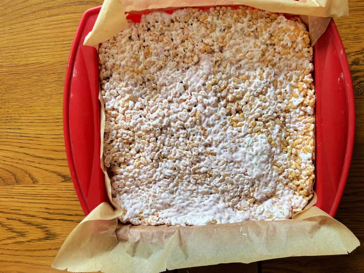 Rice Krispie treats pressed into a lined tin.