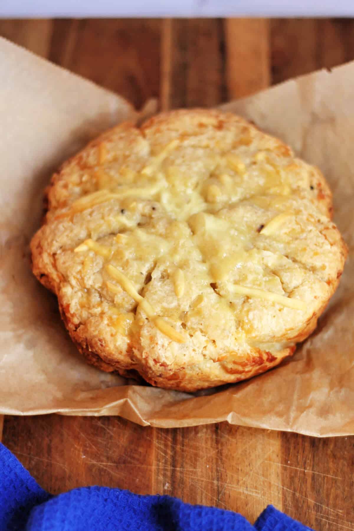 Cheese scone round on a wooden board.