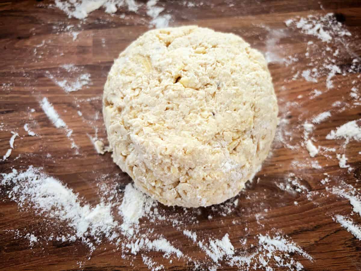 Scone dough formed into a flattened ball shape.