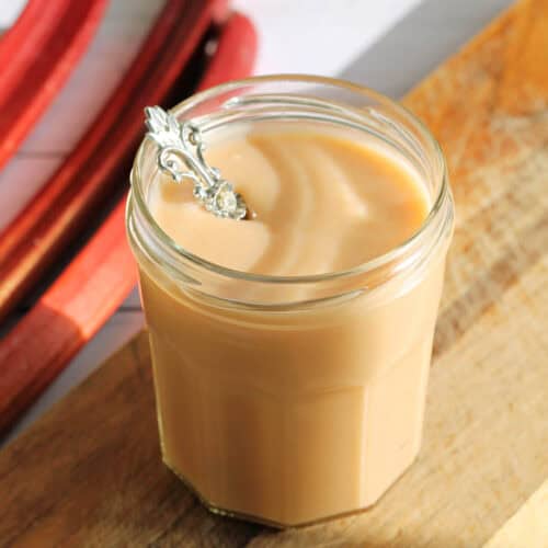 Jar of curd with a spoon in it.