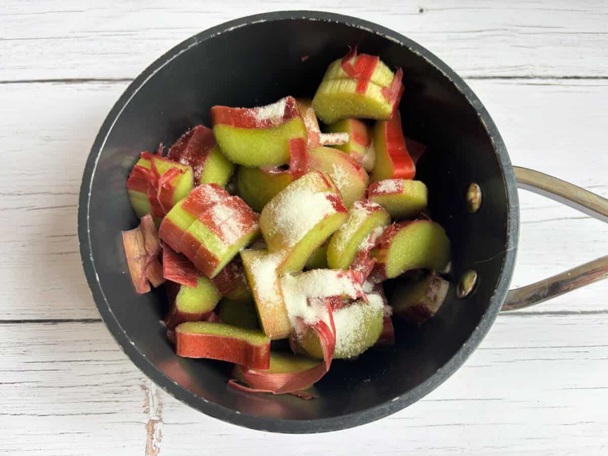 Chopped rhubarb with sugar in a small saucepan.