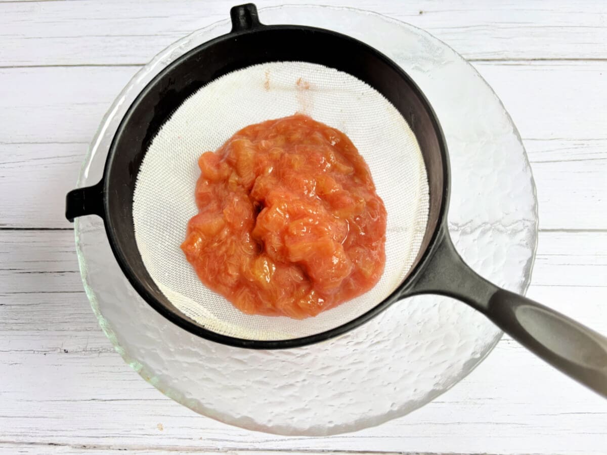 Rhubarb puree in a sieve.