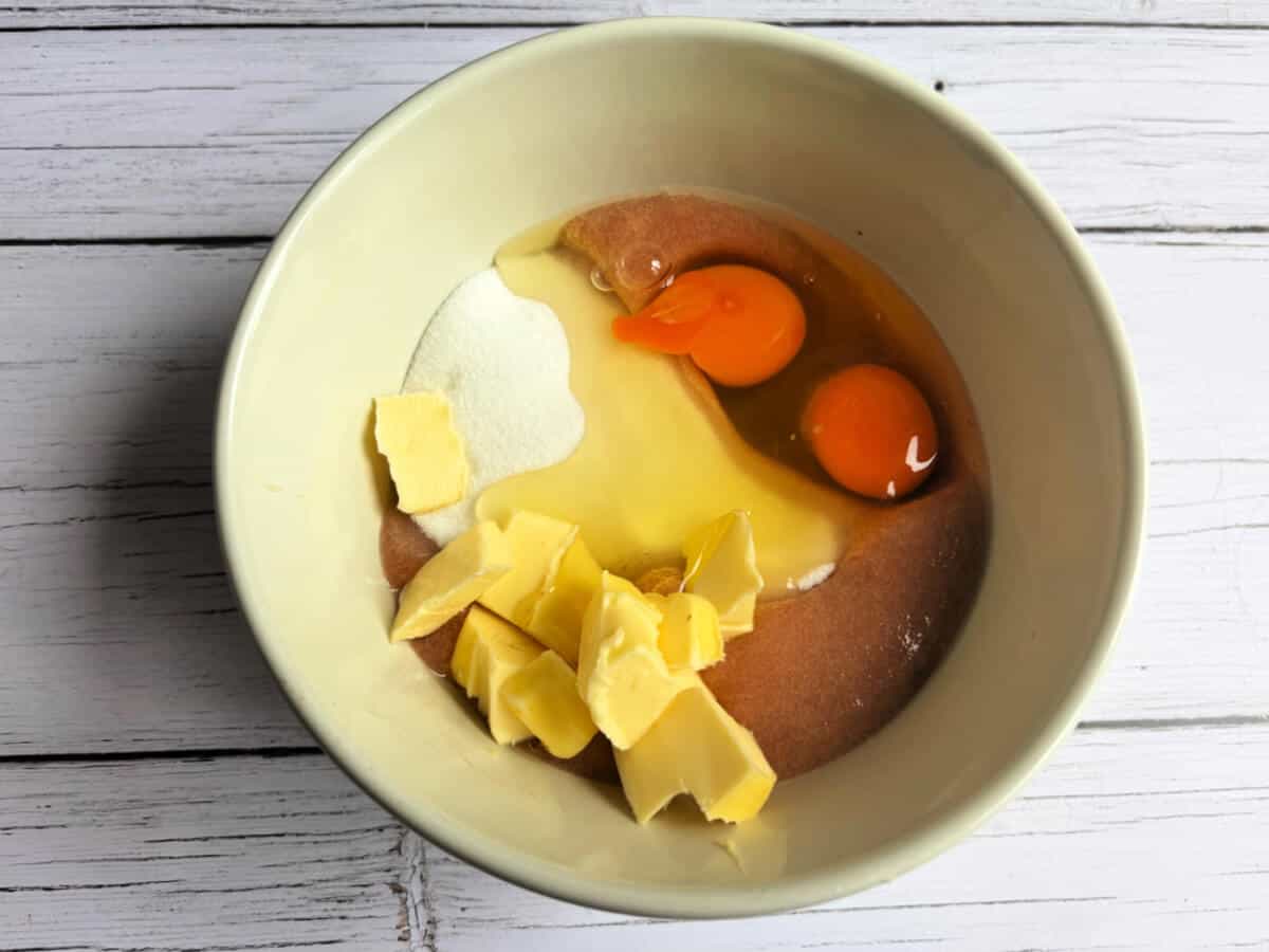 Ceramic bowl with rhubarb puree, butter, sugar and eggs.