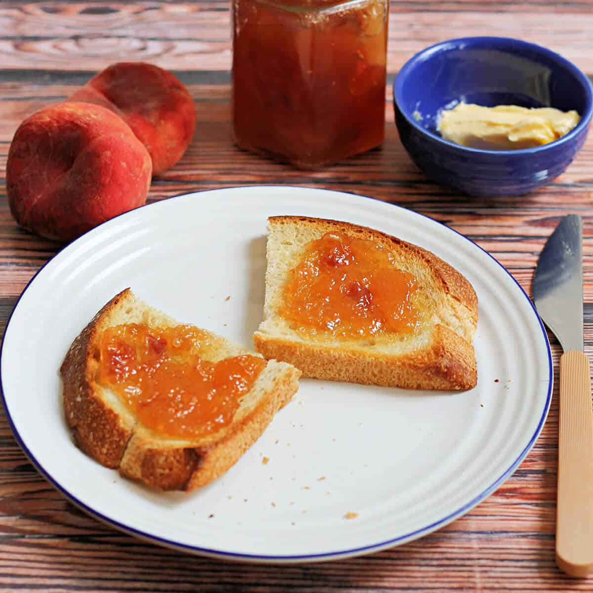 Jam on toast on a white plate.